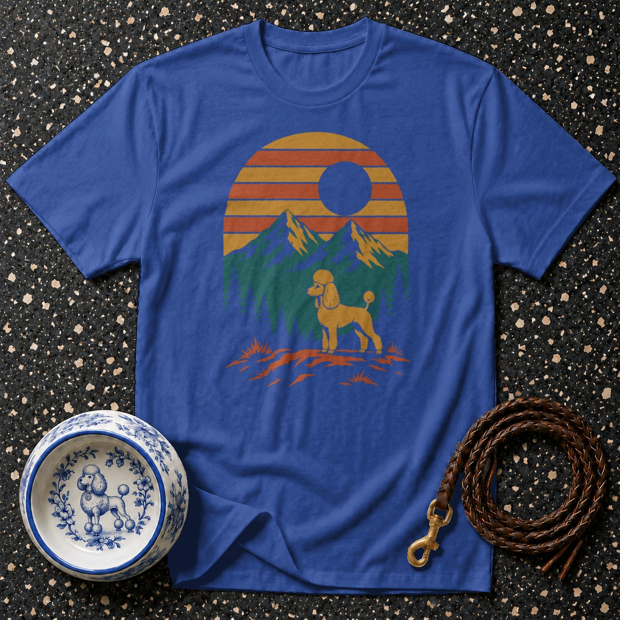 Blue t-shirt with poodle, mountains, and sunset graphic.