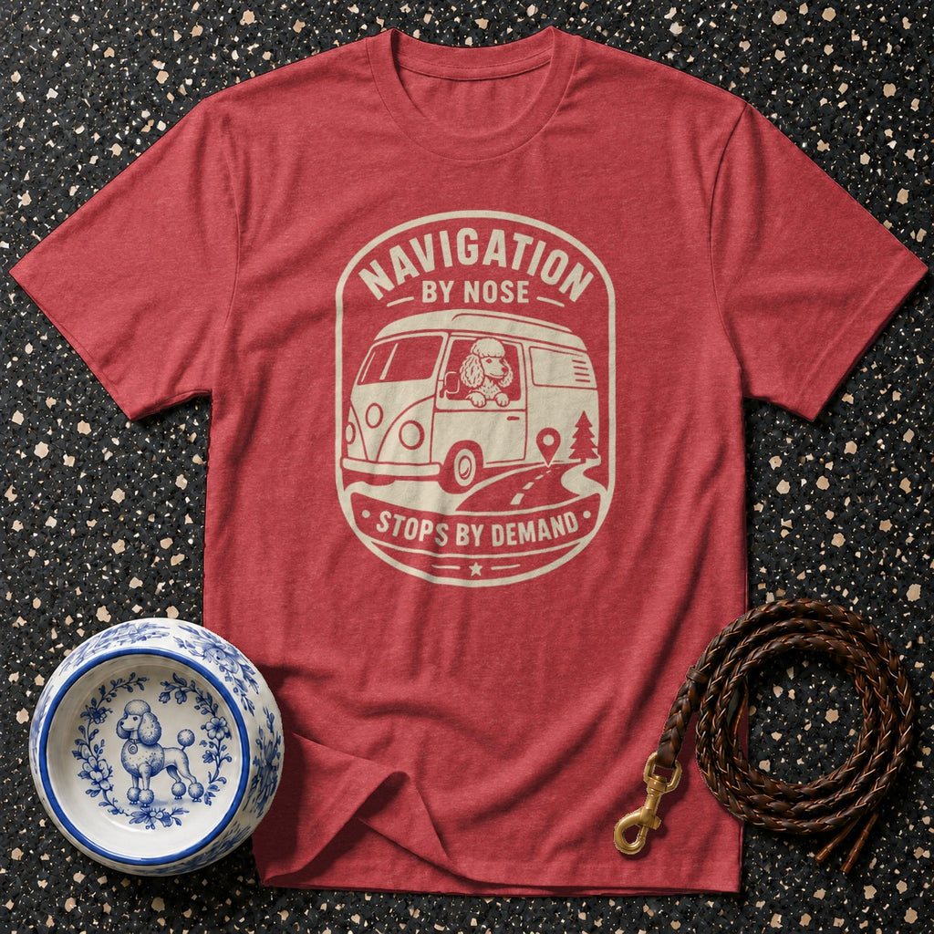 Red t-shirt featuring a graphic of a poodle driving a van with text "Navigation by Nose Stops by Demand".