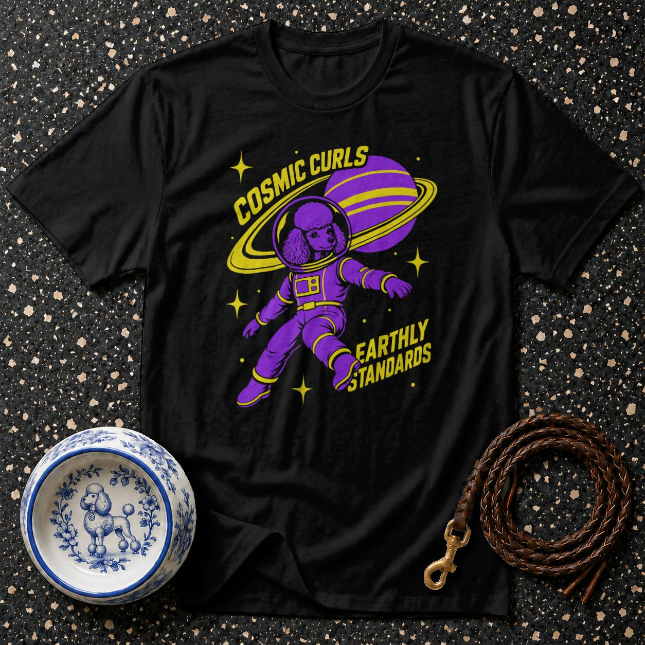 Black t-shirt with purple poodle astronaut, ringed planet, and text "Cosmic Curls Earthly Standards".