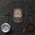 T-shirt with graphic of a crowned poodle and text "Magical. Judgmental. Curly."