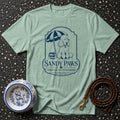 Light green t-shirt featuring a navy blue graphic of a poodle with "Sandy Paws" text.