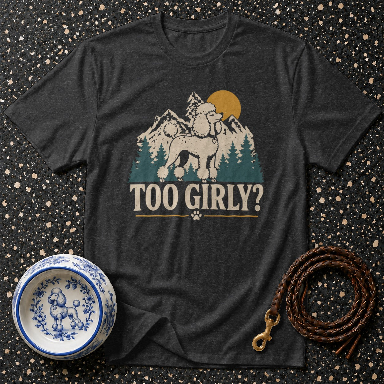 Dark grey t-shirt with a stylized poodle in mountains and the text "TOO GIRLY?".