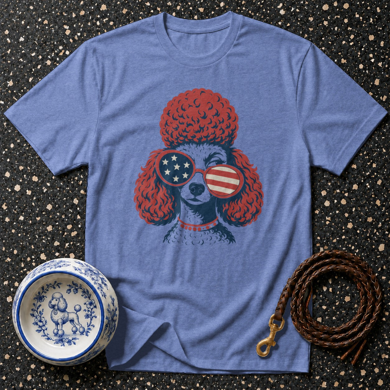 Blue t-shirt with a poodle graphic wearing American flag sunglasses and a braided leash.