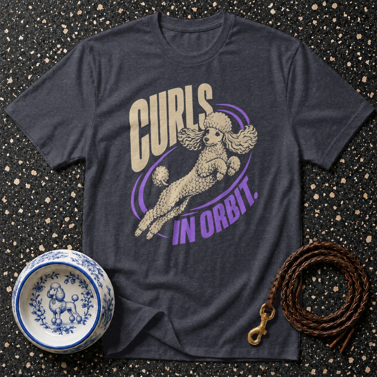 Dark gray t-shirt with graphic of poodle in orbit and text "Curls in Orbit."