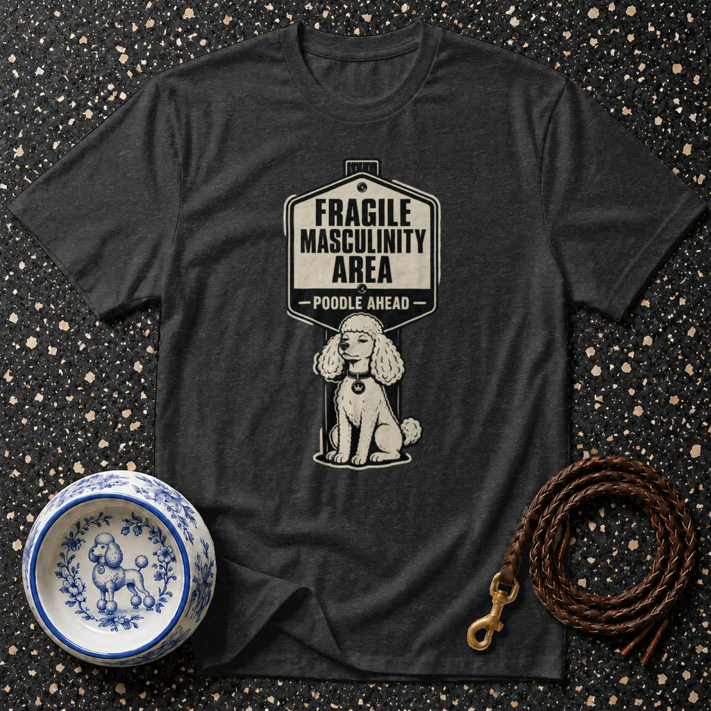 Dark t-shirt with a sign graphic reading "FRAGILE MASCULINITY AREA - POODLE AHEAD" and a poodle illustration.