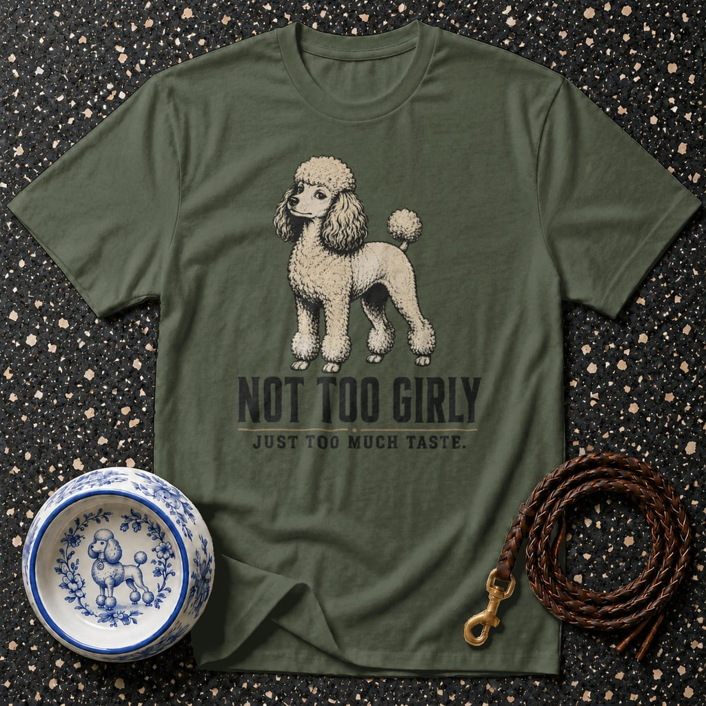 Olive green t-shirt with a poodle graphic and text "NOT TOO GIRLY JUST TOO MUCH TASTE."