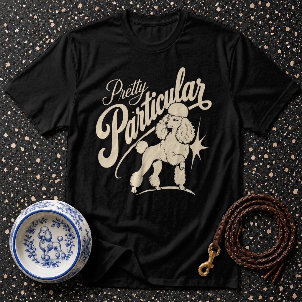 Black t-shirt with "Pretty Particular" text and a poodle illustration.
