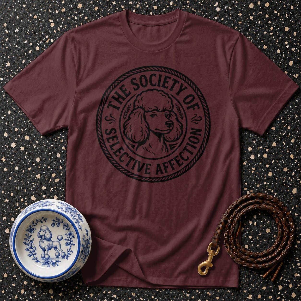 Maroon t-shirt with black poodle graphic and text saying "The Society of Selective Affection".