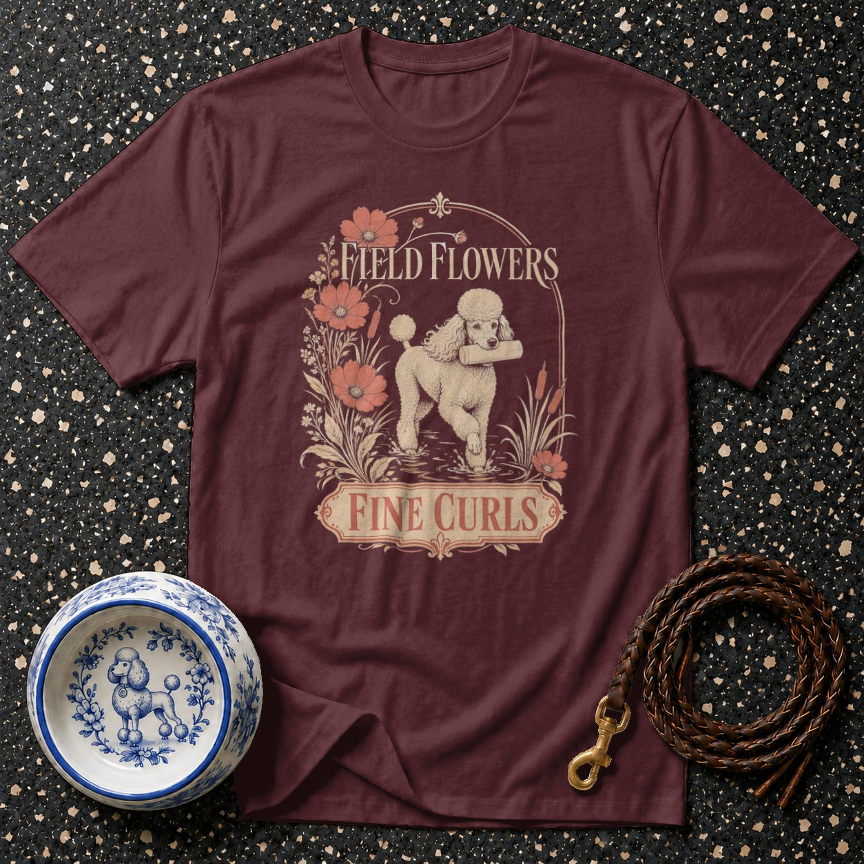 Maroon t-shirt with a poodle, flowers, and "Fine Curls" text graphic.