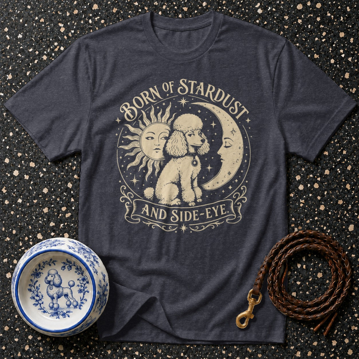 T-shirt with poodle graphic, sun, moon, and text "Born of Stardust and Side-Eye".
