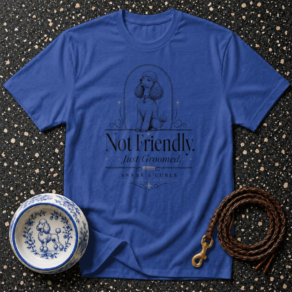 Blue t-shirt with "Not Friendly. Just Groomed." poodle graphic and dog accessories.