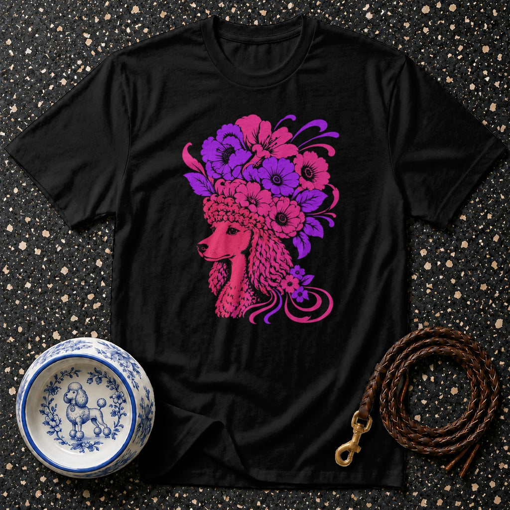 Black t-shirt featuring a pink poodle with a vibrant floral crown in shades of pink and purple.