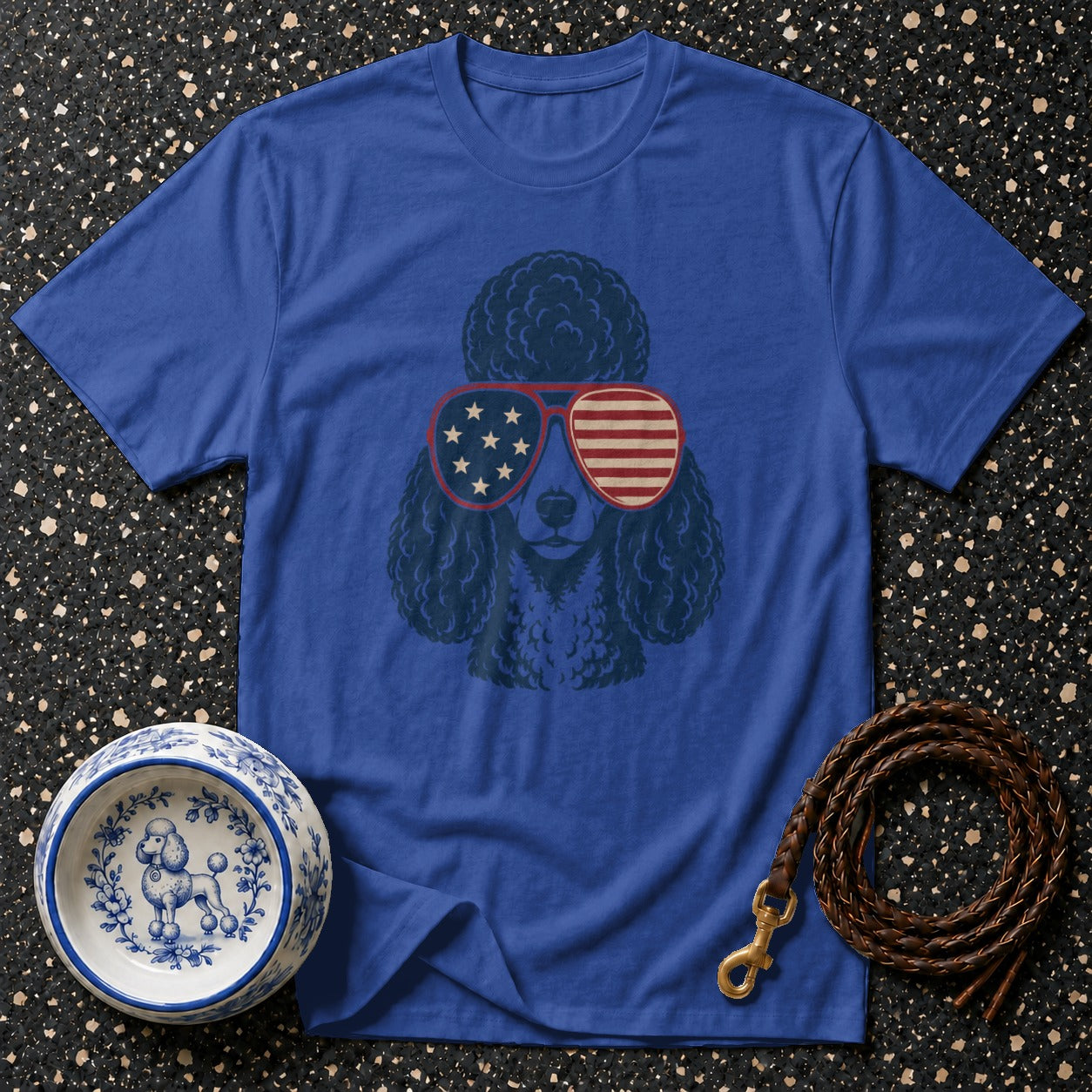 Blue t-shirt with poodle wearing patriotic sunglasses, dog bowl, and leash.