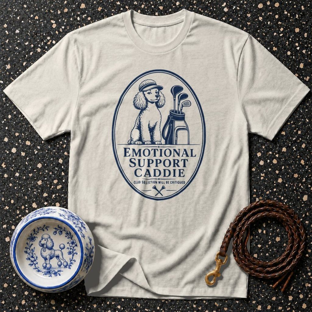 T-shirt with blue graphic of a poodle wearing a golf hat, golf bag, clubs, and text: Emotional Support Caddie.