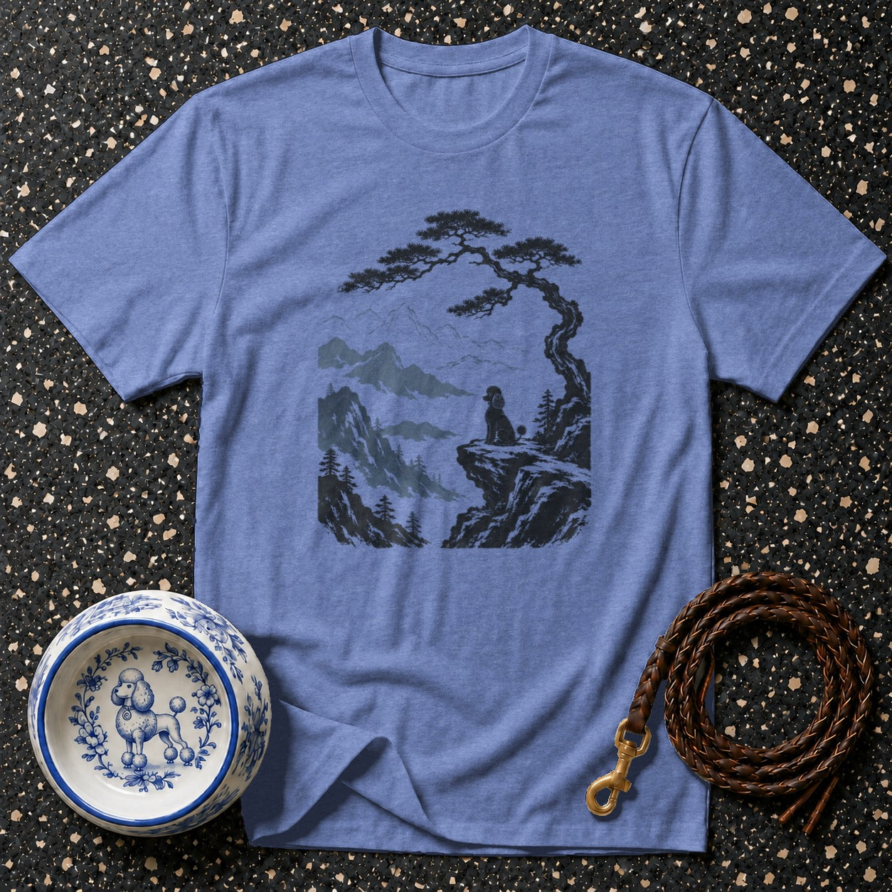 T-shirt with a black poodle silhouette on a cliff overlooking mountains.
