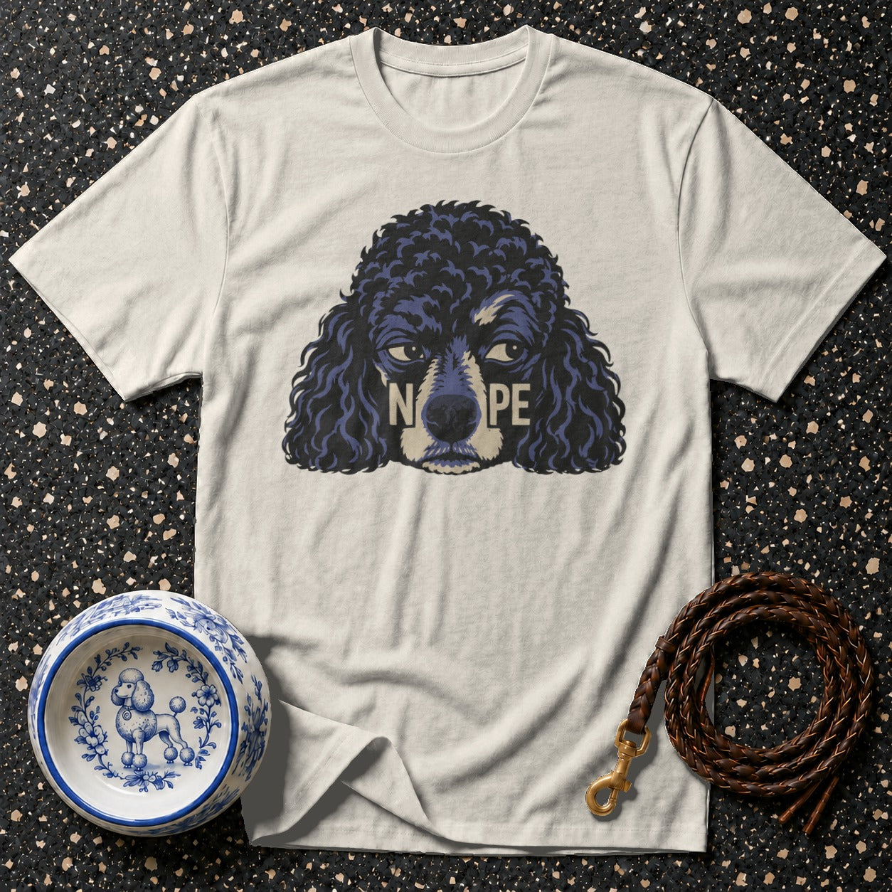 T-shirt with a dark blue poodle graphic saying "NOPE" and decorative dog bowl.