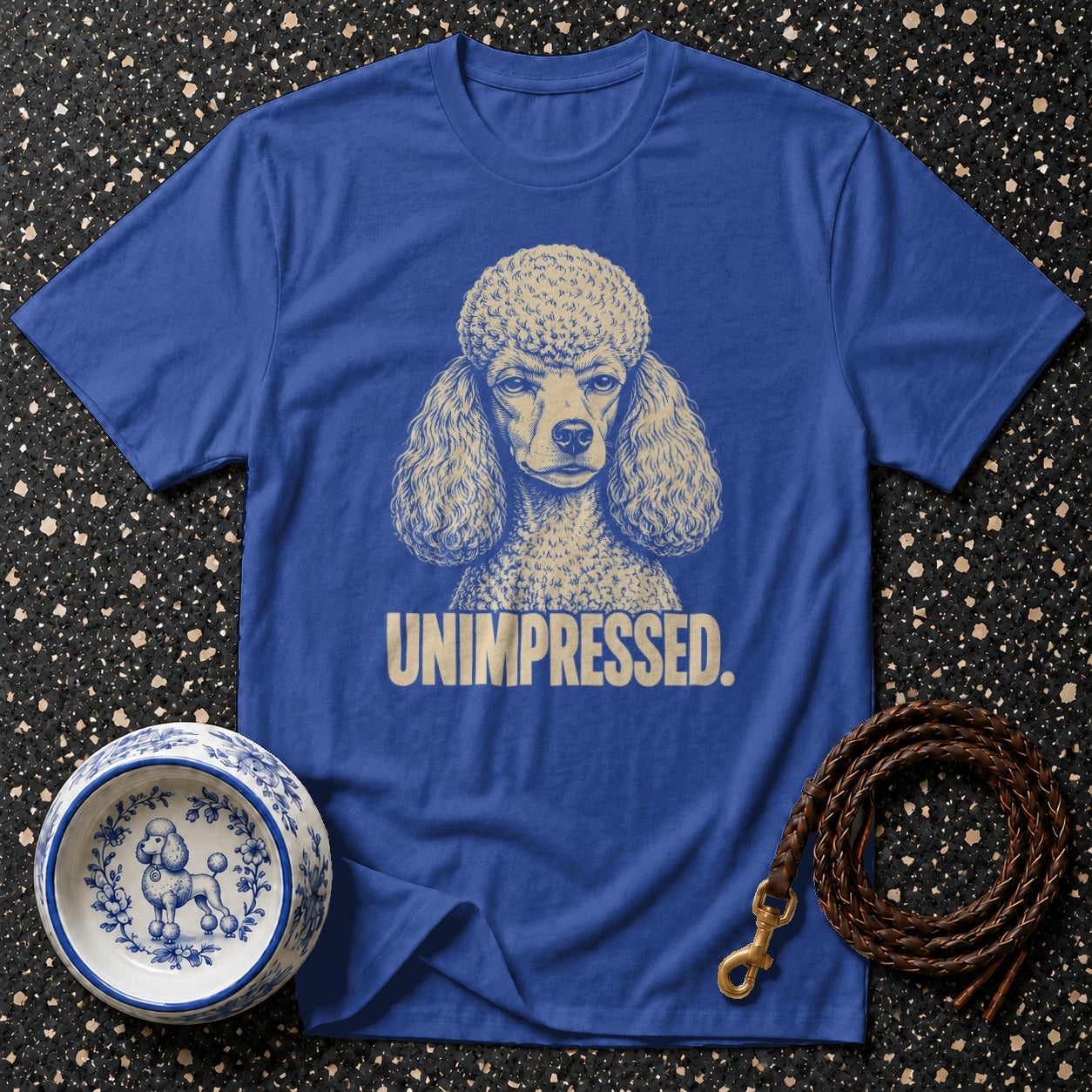 Blue t-shirt with a poodle graphic and "UNIMPRESSED." text.