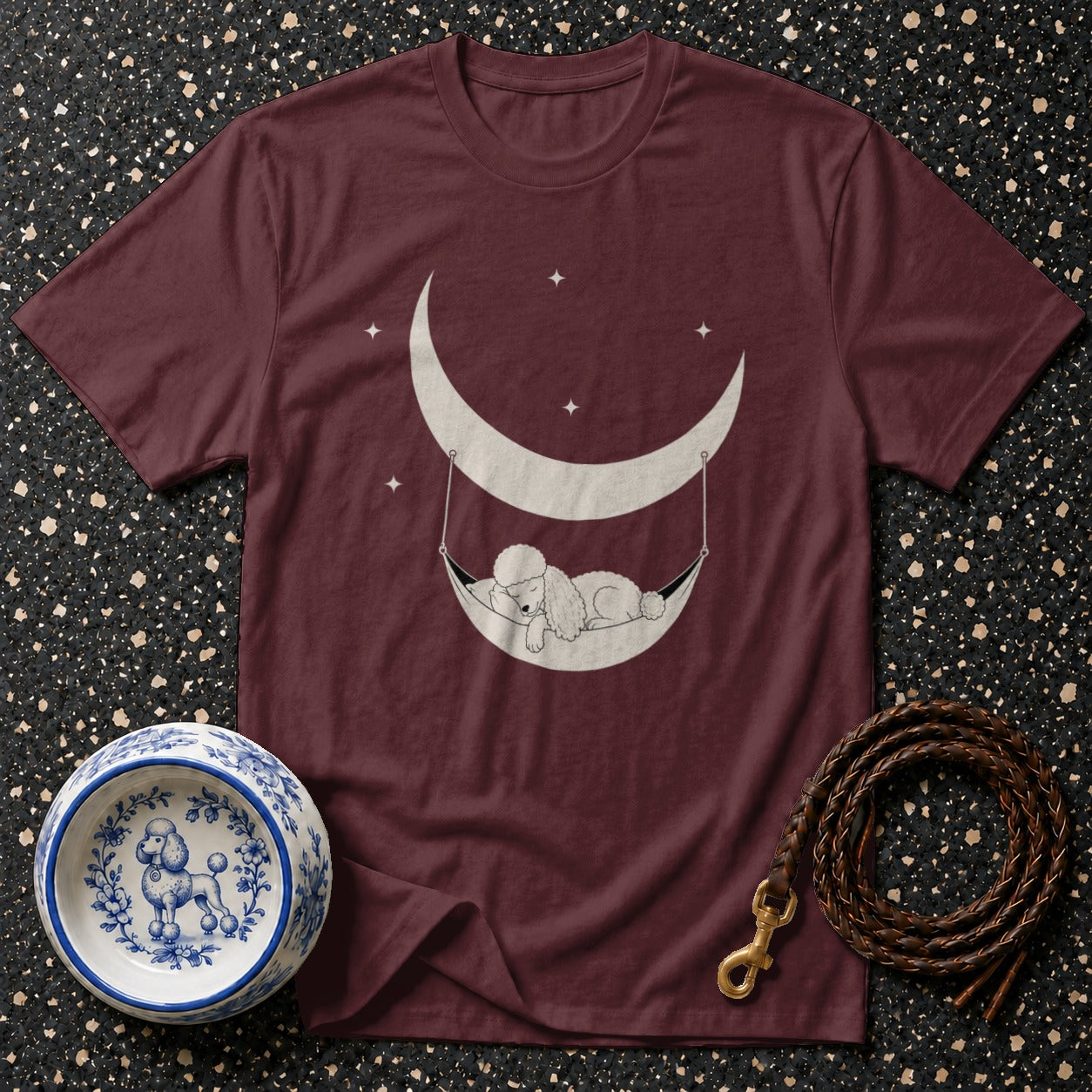 Maroon t-shirt with poodle sleeping in a crescent moon hammock graphic.