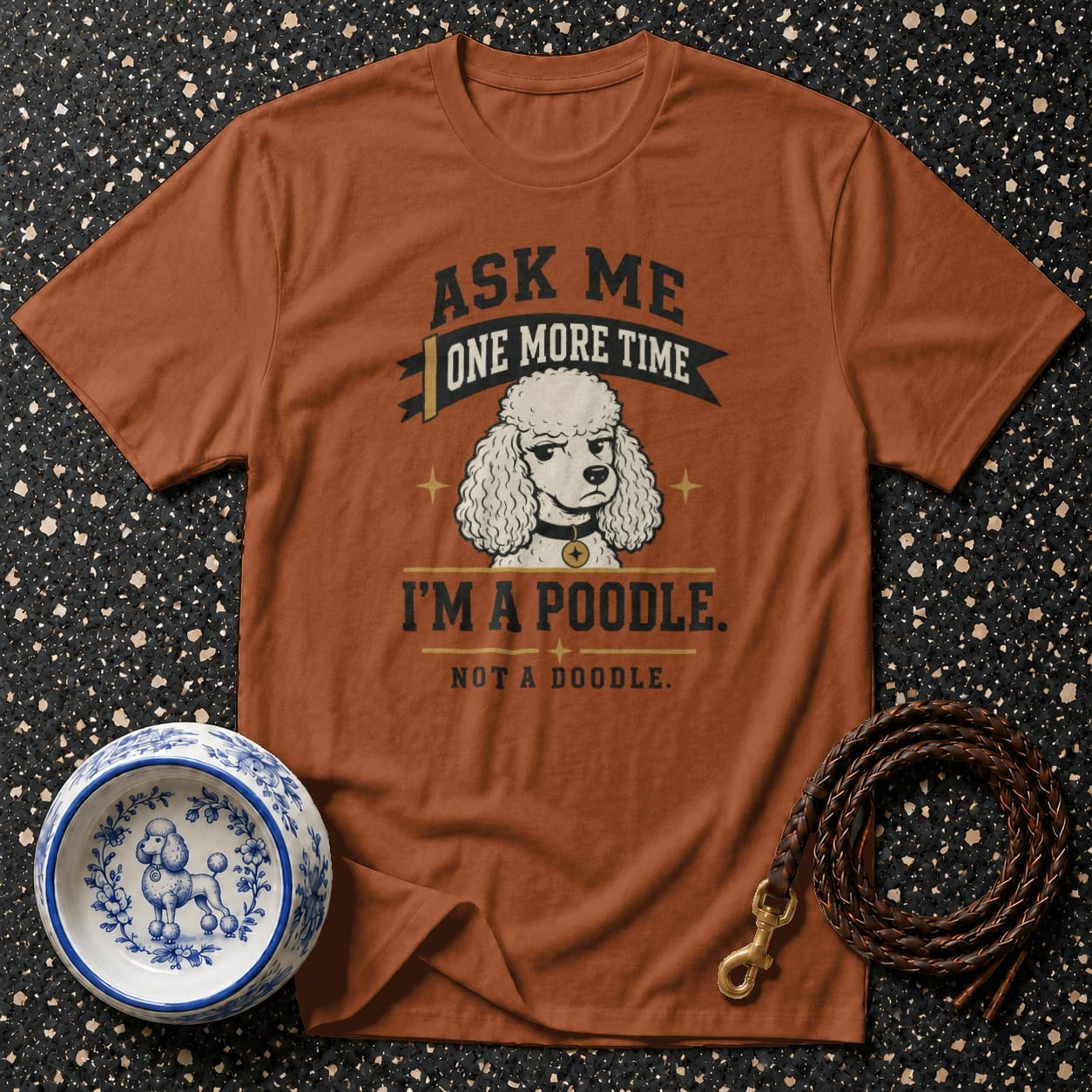 Brown t-shirt with text "Ask me one more time, I'm a poodle. Not a doodle." and poodle illustration.