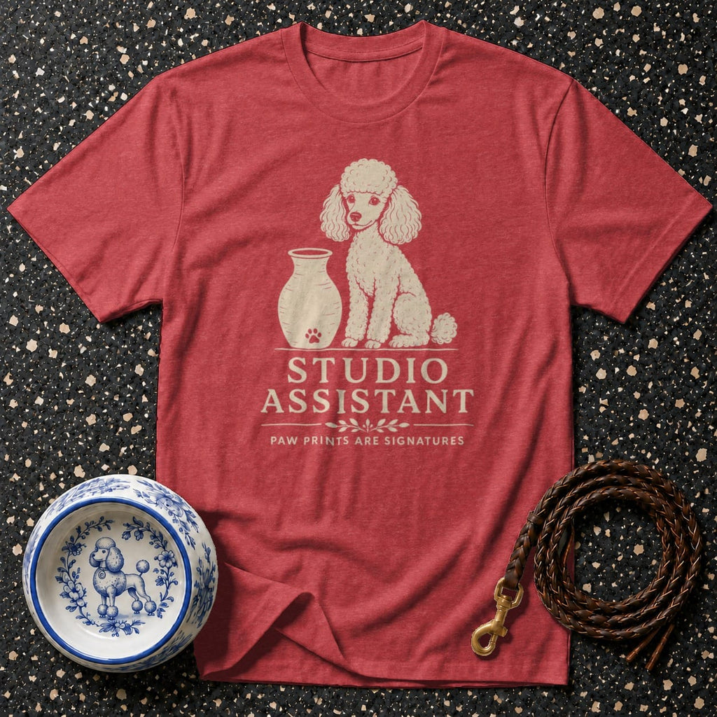 Red t-shirt with a cream poodle graphic and text "STUDIO ASSISTANT".