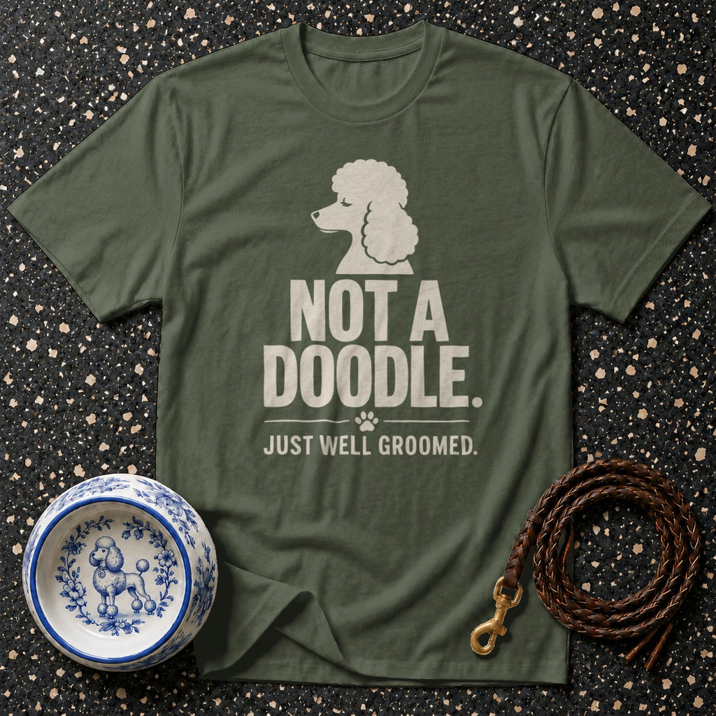 Green t-shirt with white poodle graphic and text "NOT A DOODLE. JUST WELL GROOMED."