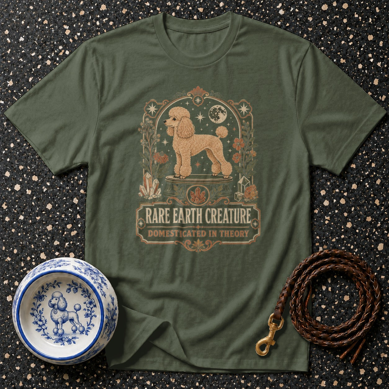 Green t-shirt with poodle graphic and text "Rare Earth Creature Domesticated in Theory".