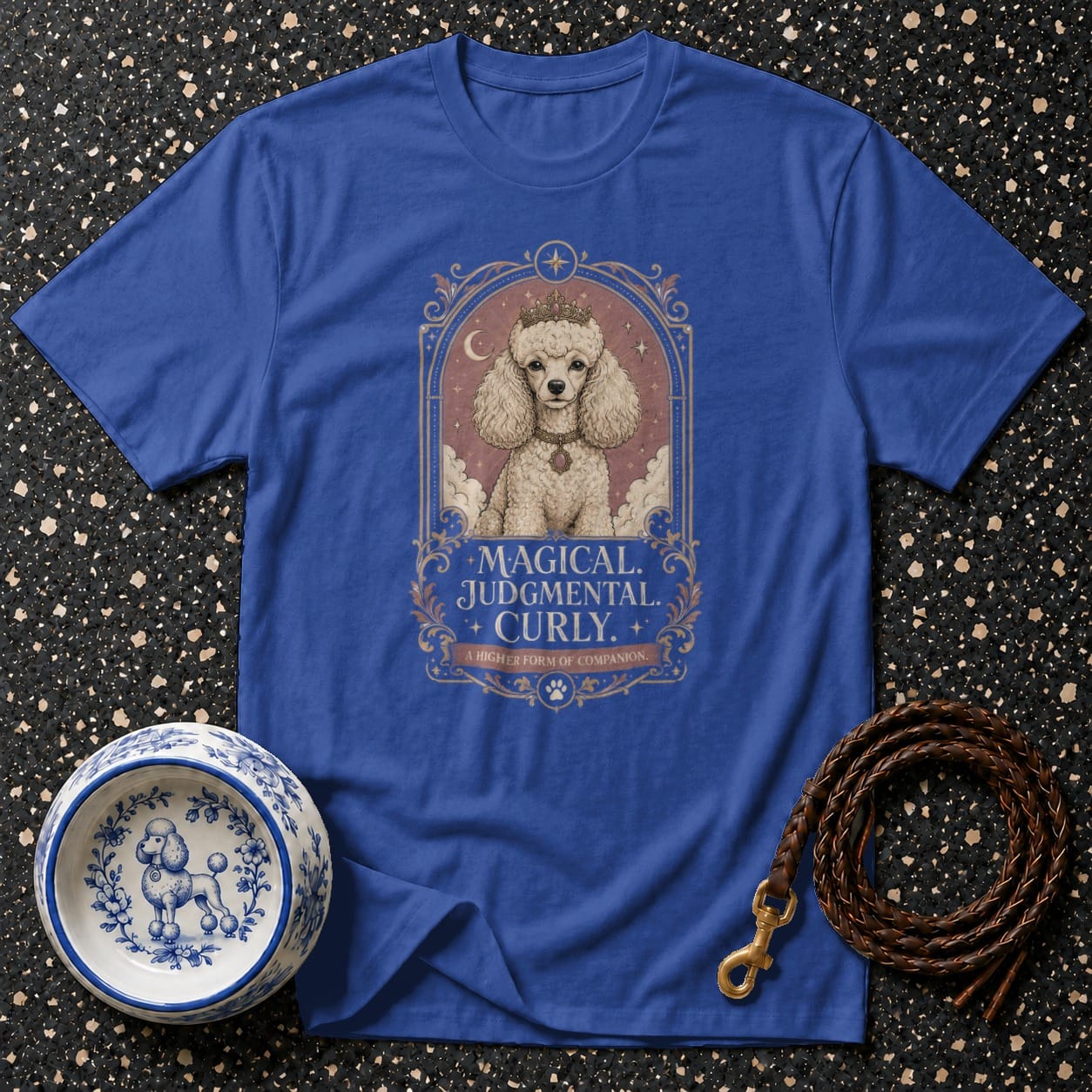 Blue t-shirt with a poodle wearing a crown and the text "Magical. Judgmental. Curly."