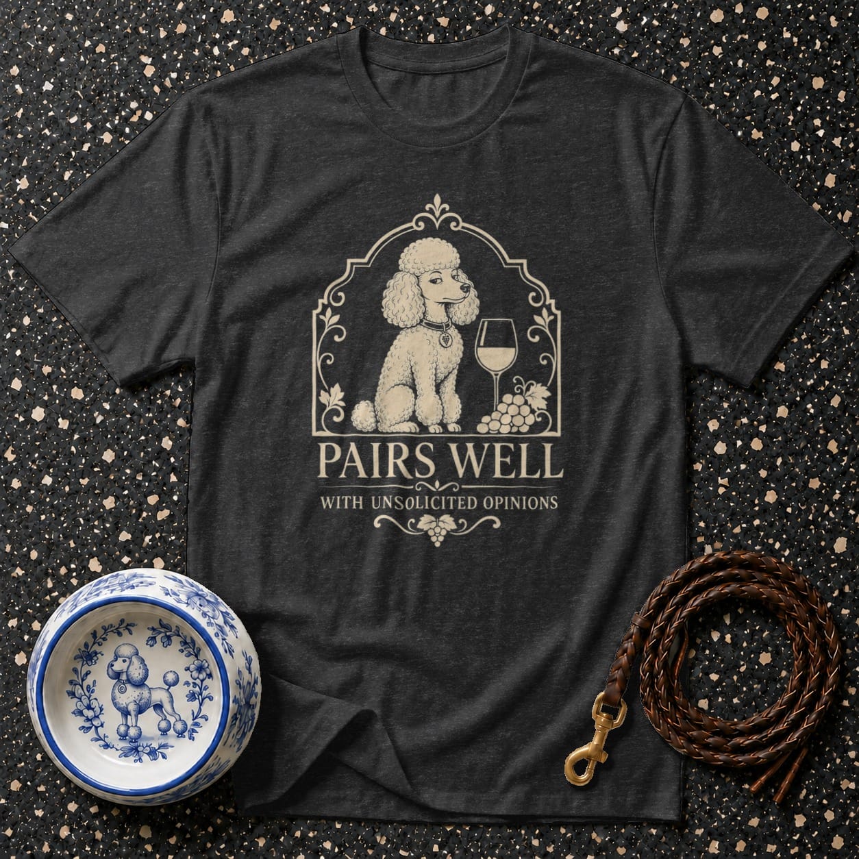 Dark gray t-shirt with a poodle, wine glass, grapes, and "Pairs Well With Unsolicited Opinions" text.