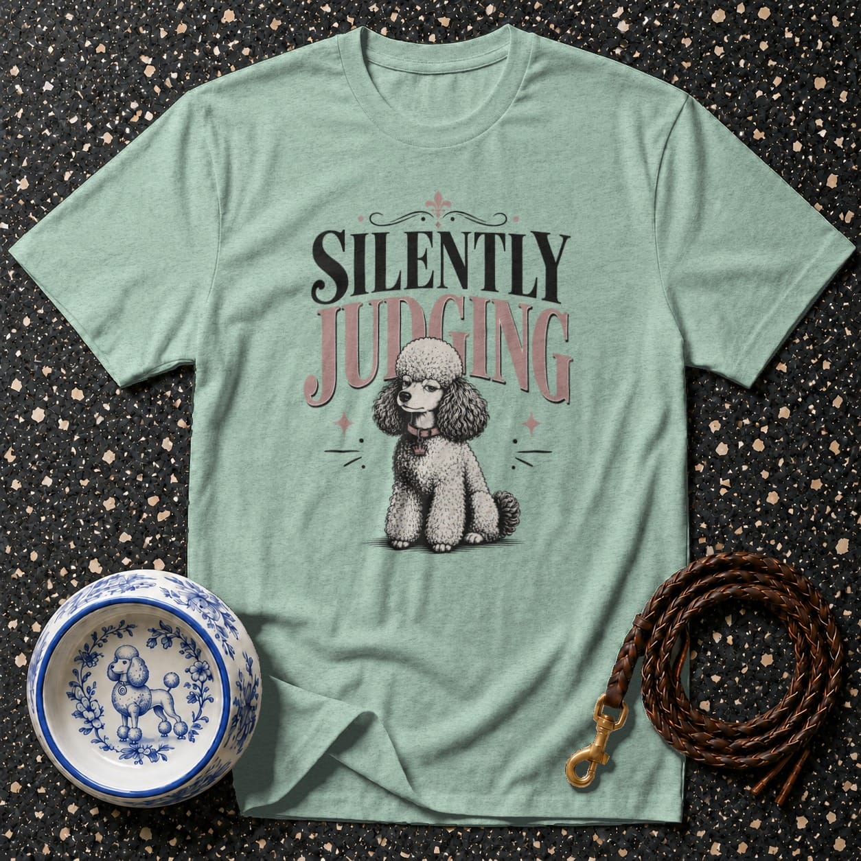 Light blue t-shirt with a poodle graphic and text "SILENTLY JUDGING".