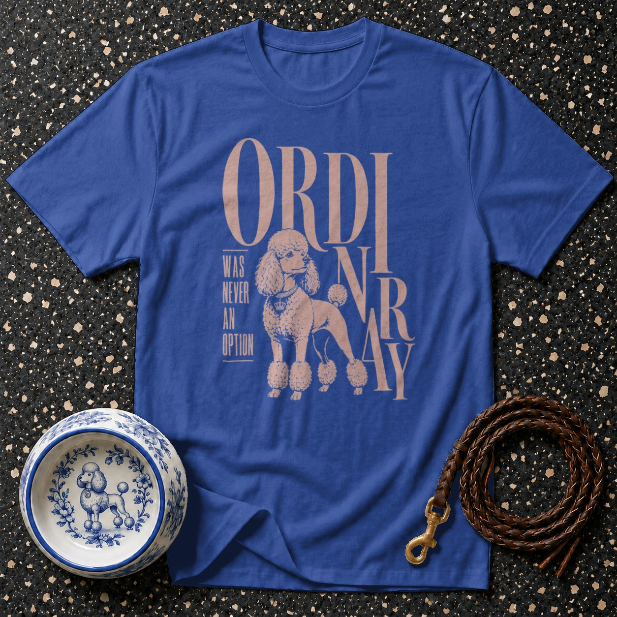 Blue t-shirt with poodle graphic and text "ORDINARY WAS NEVER AN OPTION".