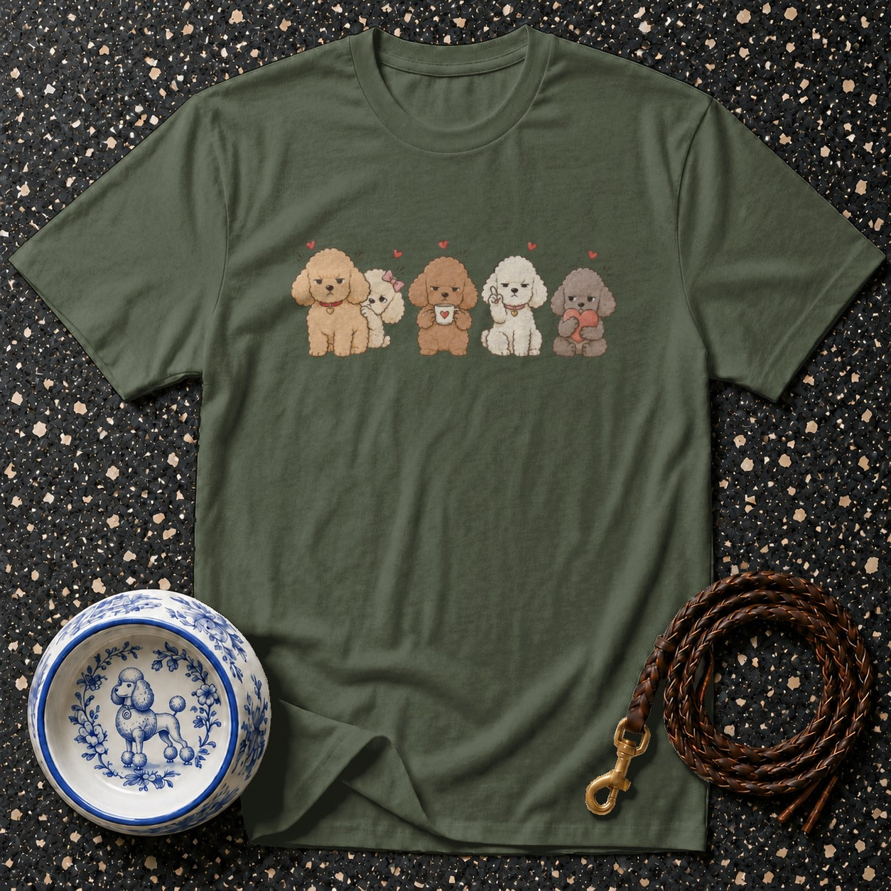 Green t-shirt with five cartoon poodles and a decorative dog bowl.