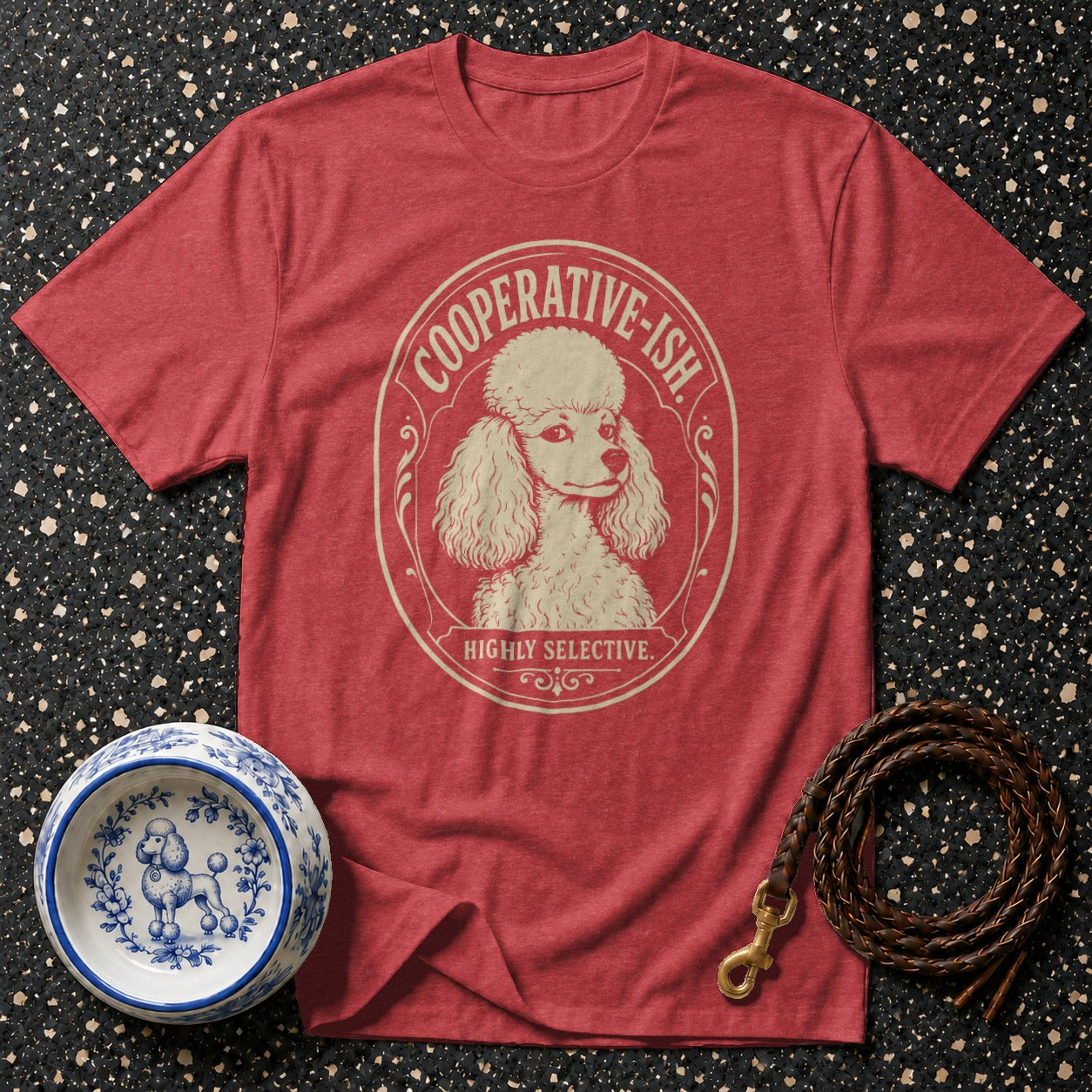 Red t-shirt with cream poodle graphic and text "COOPERATIVE-ISH. HIGHLY SELECTIVE."