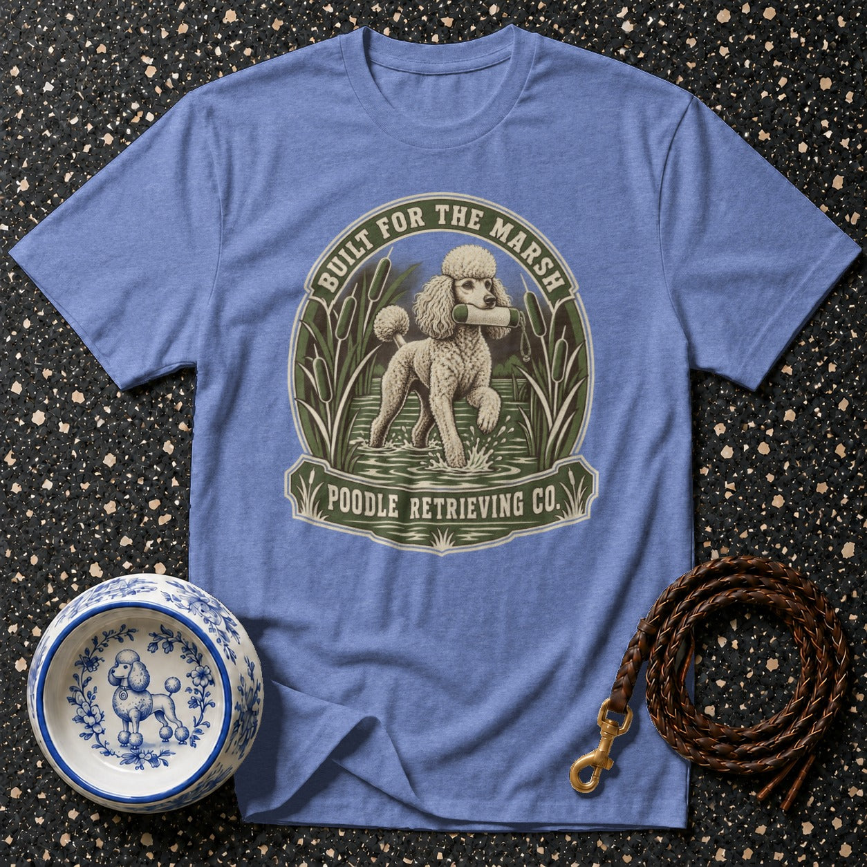 Blue t-shirt with a poodle retrieving in the marsh, text says "Built for the Marsh Poodle Retrieving Co."