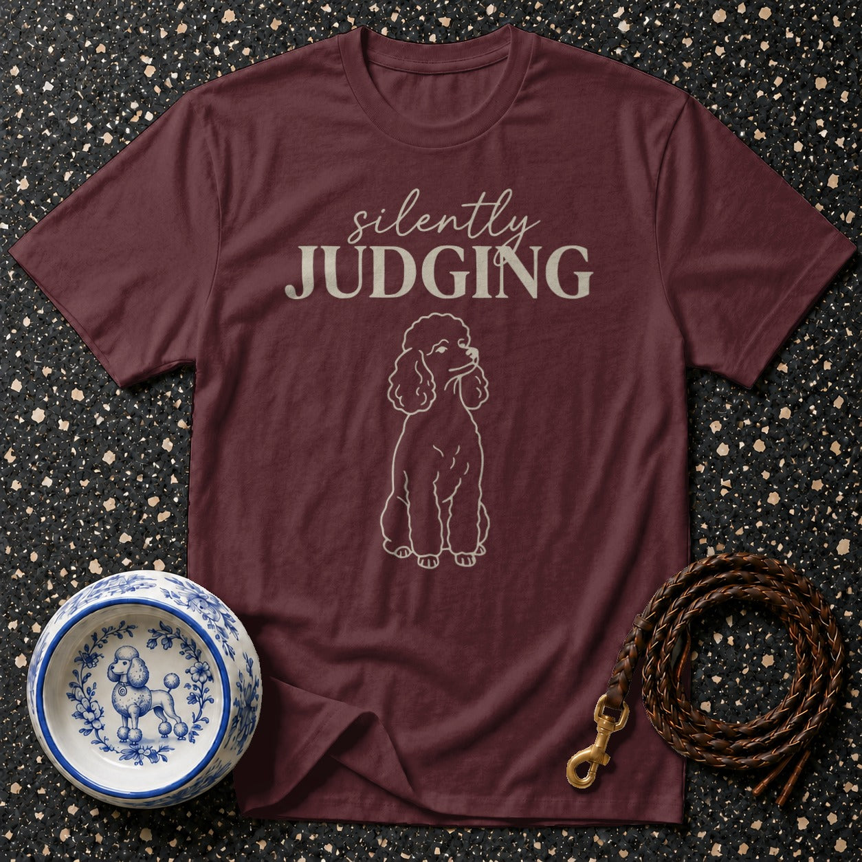Maroon t-shirt with white poodle graphic and text "silently JUDGING".