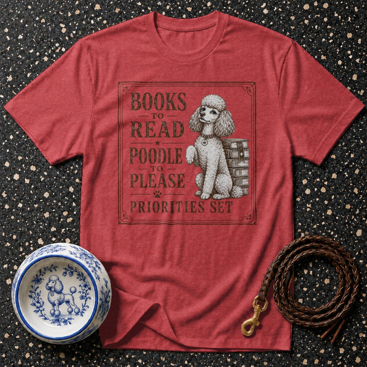 Red t-shirt with slogan "BOOKS TO READ POODLE TO PLEASE PRIORITIES SET" and poodle illustration.