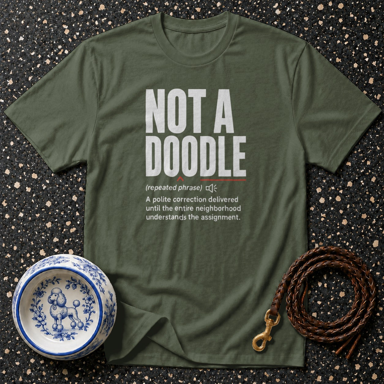 Green t-shirt with "NOT A DOODLE" text and definition.