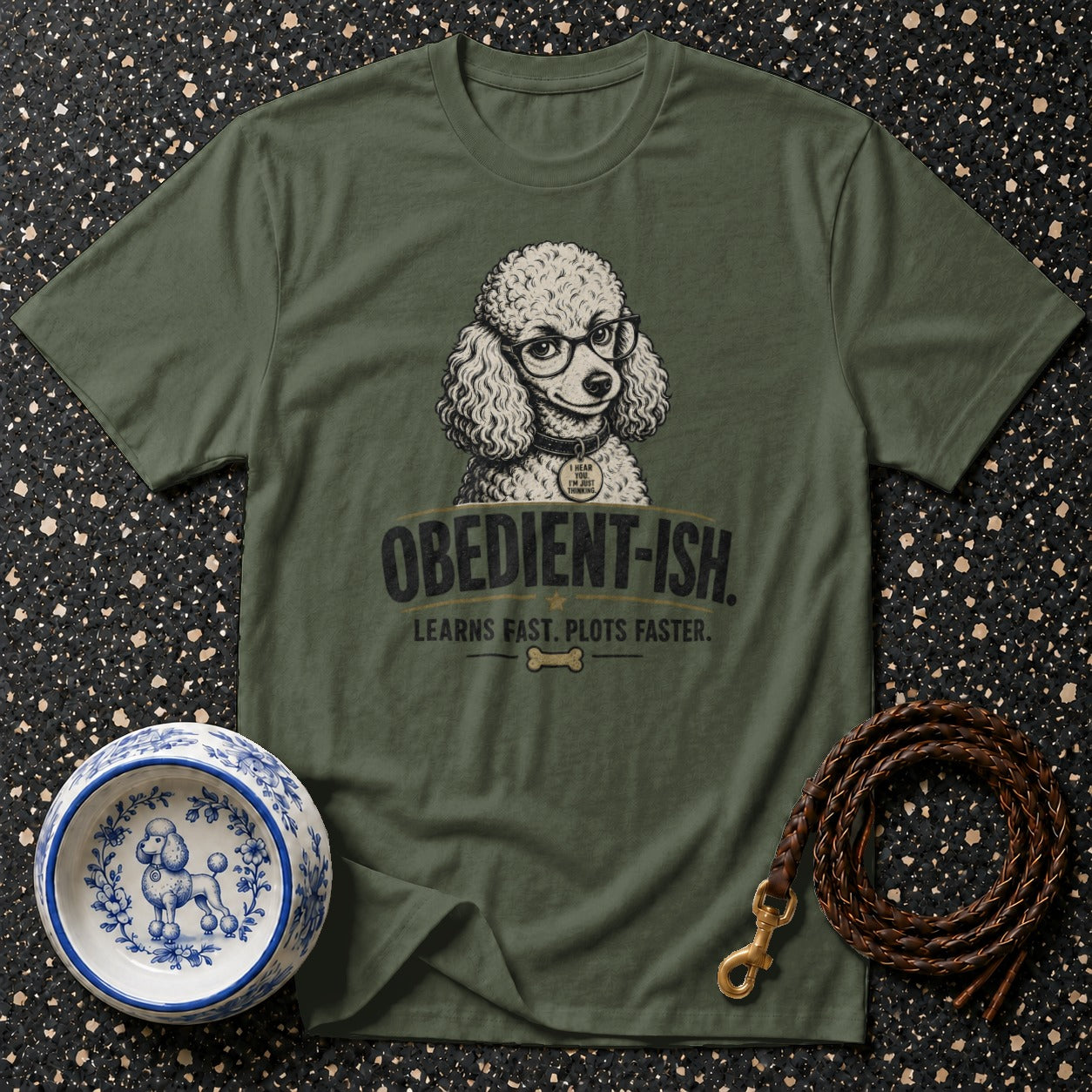 Olive green t-shirt with a poodle wearing glasses and the text "OBEDIENT-ISH."