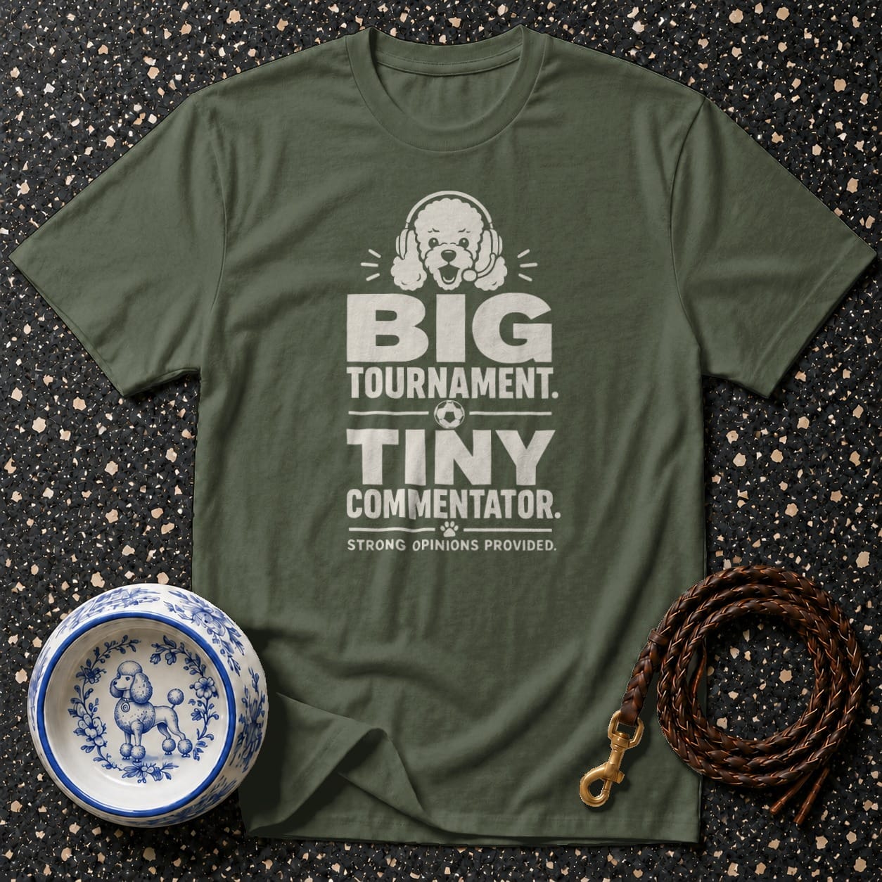 Green t-shirt with white text: "BIG TOURNAMENT. TINY COMMENTATOR. STRONG OPINIONS PROVIDED."