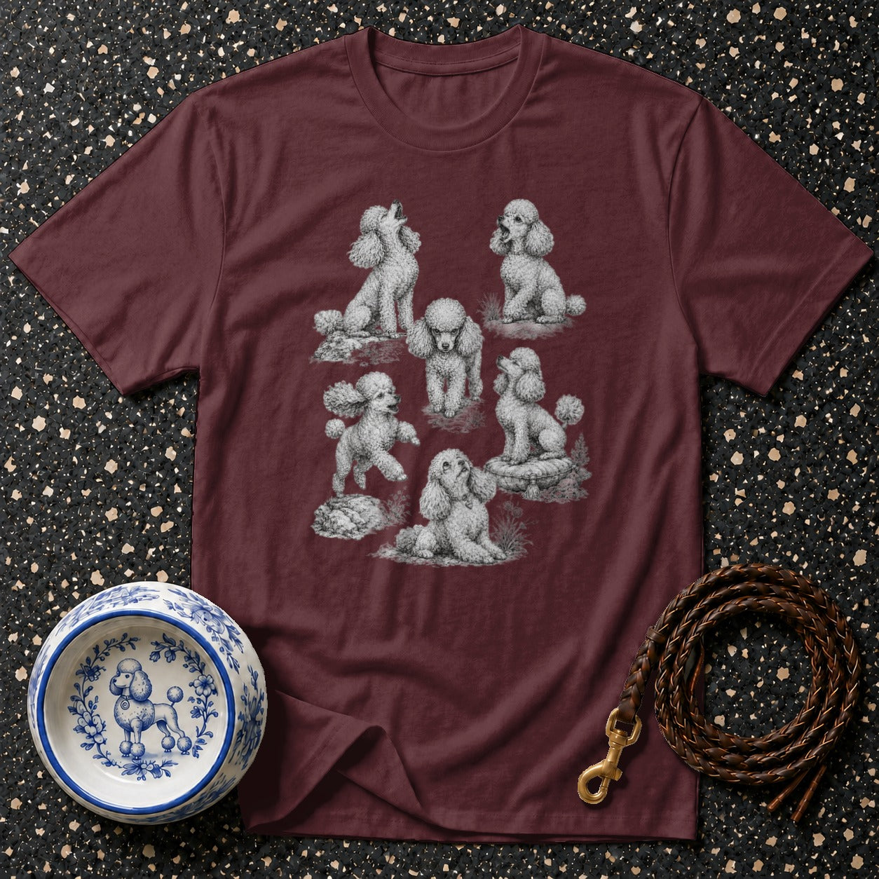 Maroon t-shirt with multiple poodle sketches and a decorative poodle bowl.