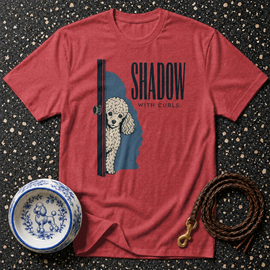Red t-shirt with poodle peeking from behind a door and text "SHADOW WITH CURLS."