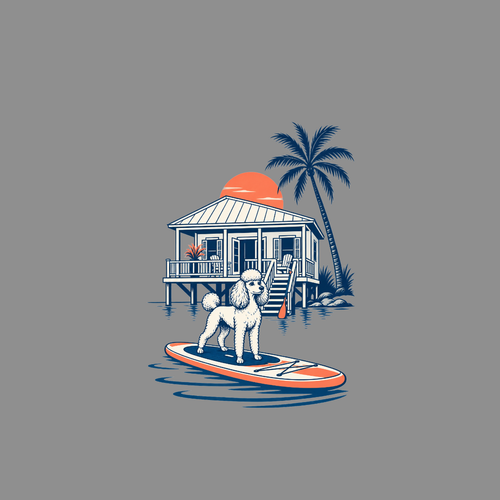 White poodle stands on surfboard in front of stilted beach house at sunset.