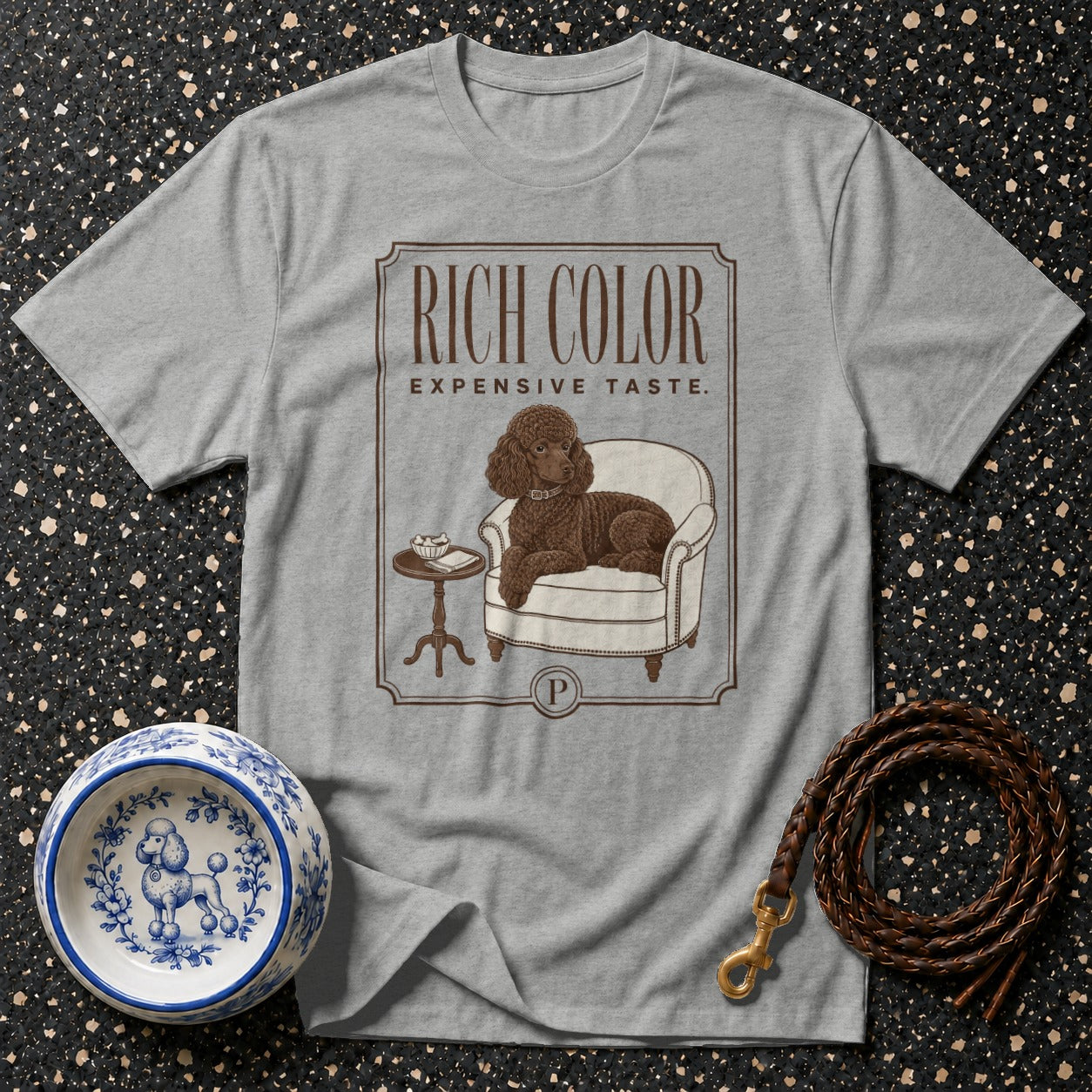Grey t-shirt with a brown poodle relaxing in a chair and text "RICH COLOR EXPENSIVE TASTE.".