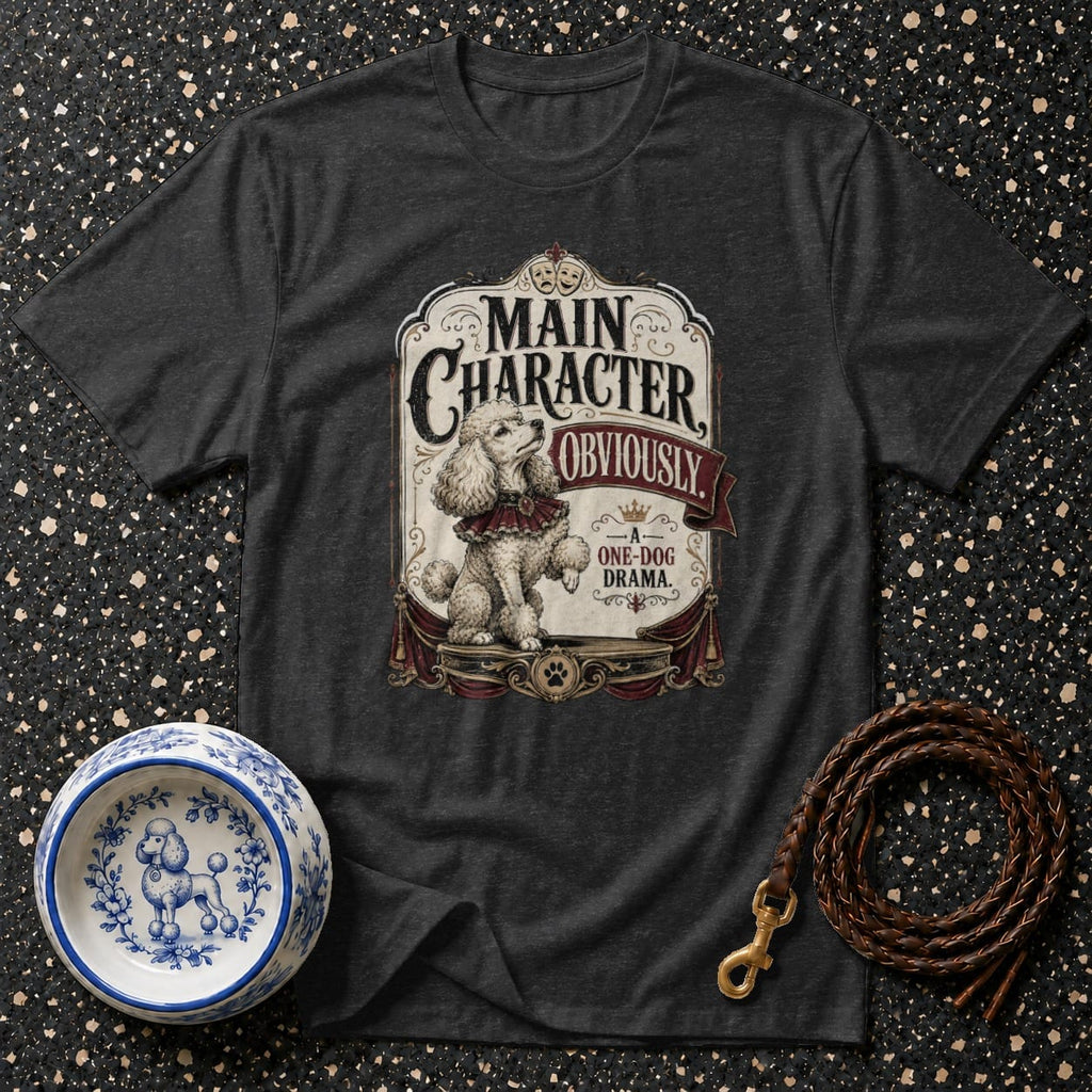 Dark grey t-shirt with poodle graphic, text "Main Character Obviously" and "A One-Dog Drama".