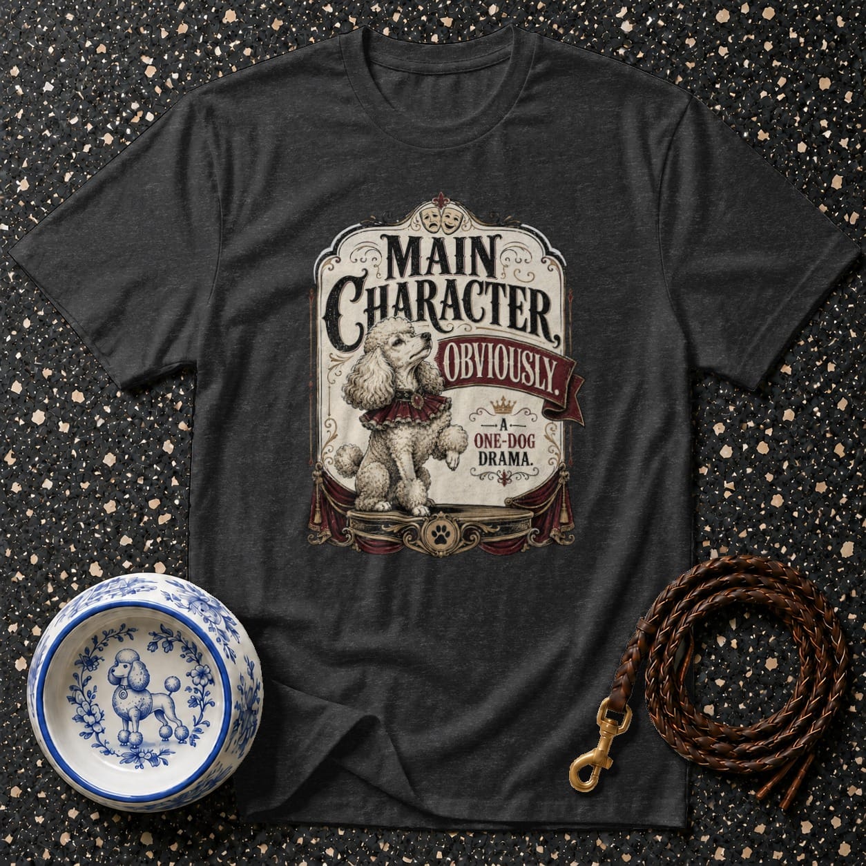 Dark grey t-shirt with poodle graphic, text "Main Character Obviously" and "A One-Dog Drama".