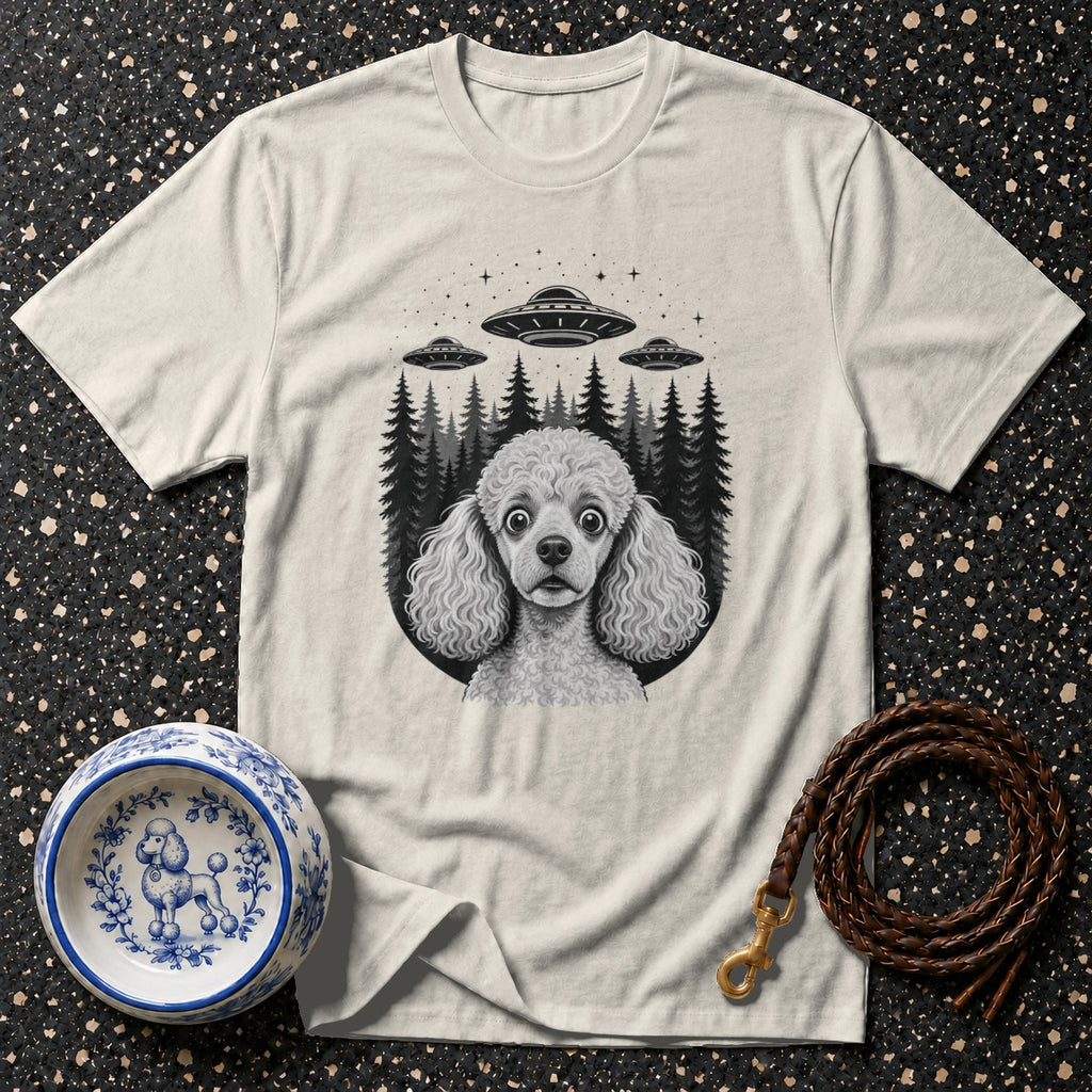 Cream t-shirt with illustrated poodle and three UFOs over a forest.