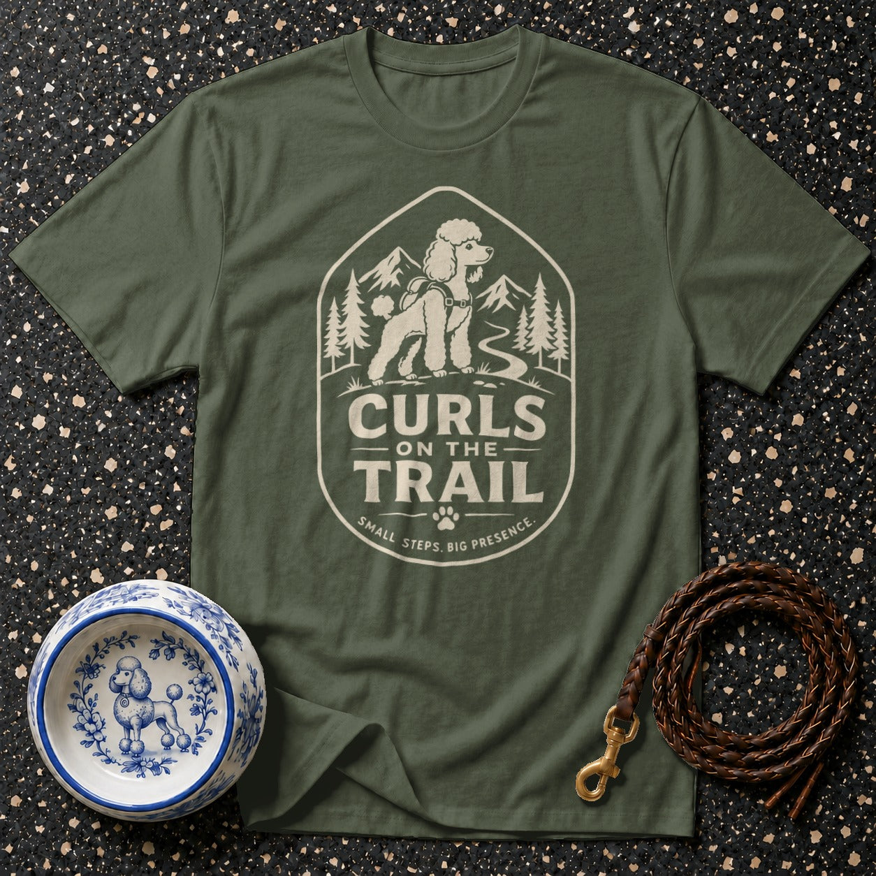 Olive green t-shirt with poodle hiking graphic and text "Curls on the Trail."