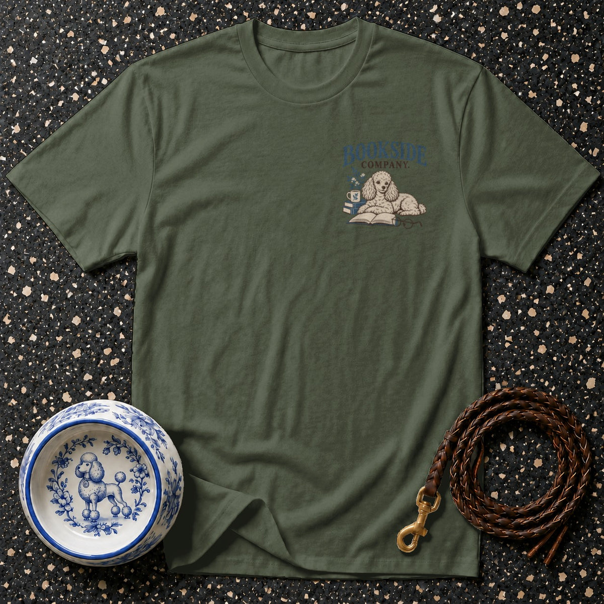 Green t-shirt with a poodle reading on books and "Bookside Company" text.