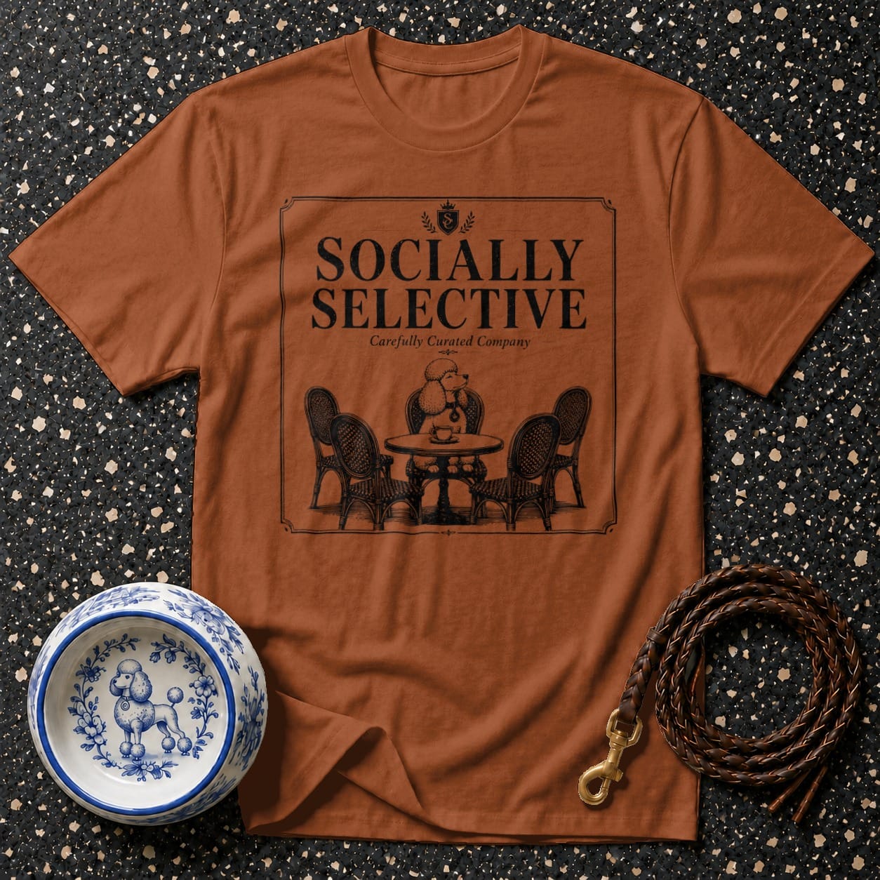 Brown t-shirt with "Socially Selective" text and poodle at cafe graphic.