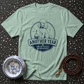 Mint t-shirt with navy graphic of a poodle and text: "Another Year Under Poodle Management."