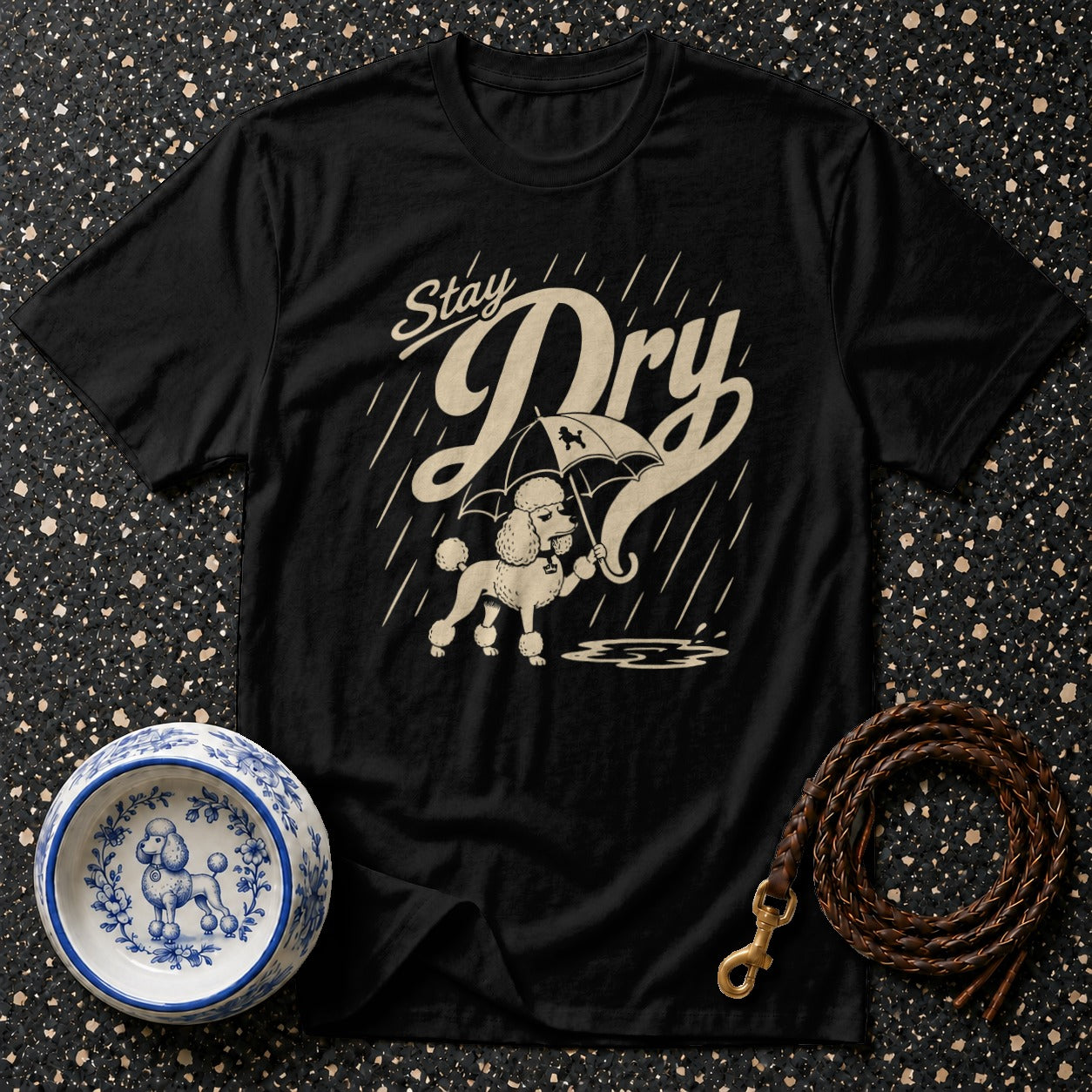 Black t-shirt with a poodle under an umbrella, text "Stay Dry", and rain.